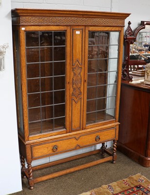 Lot 1318 - A 1920's oak bookcase with leaded glazed doors,...