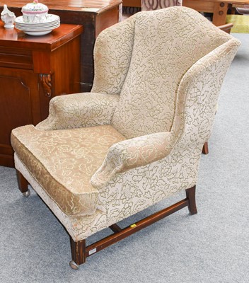 Lot 1261 - An oak framed wingback chair