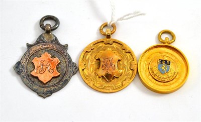 Lot 71 - Two 9ct gold sporting medallions and another in silver (3)