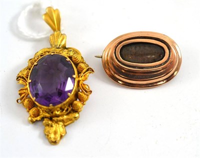 Lot 85 - An amethyst set pendant and a mourning brooch (2)
