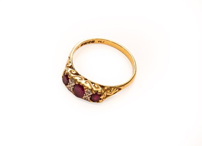 Lot 223 - An 18 carat gold ruby and diamond ring, finger...