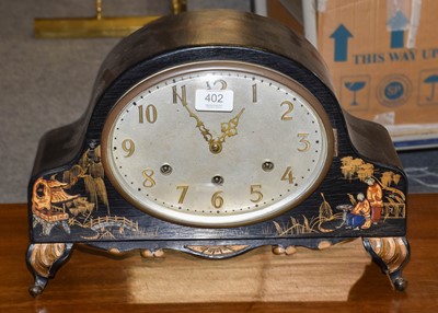 Lot 402 - A Japanned chiming mantel clock