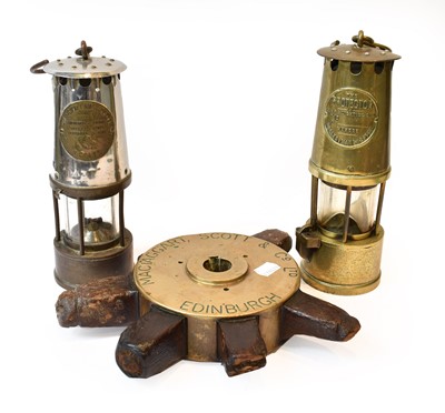 Lot 409 - Two miners lamps and a ships wheel, the centre...