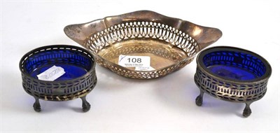 Lot 108 - Pair of silver table salts with blue glass liners and a pierced oval dish (3)