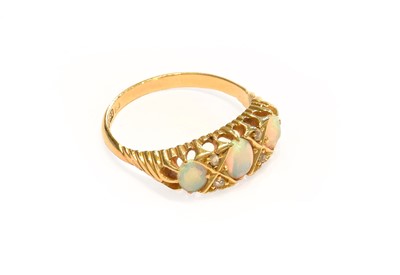 Lot 186 - An 18 carat gold opal and diamond ring, finger...
