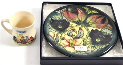 Lot 116 - A William John Moorcroft 'Hellebore' plate and a Moorcroft 1989 museum mug (2)