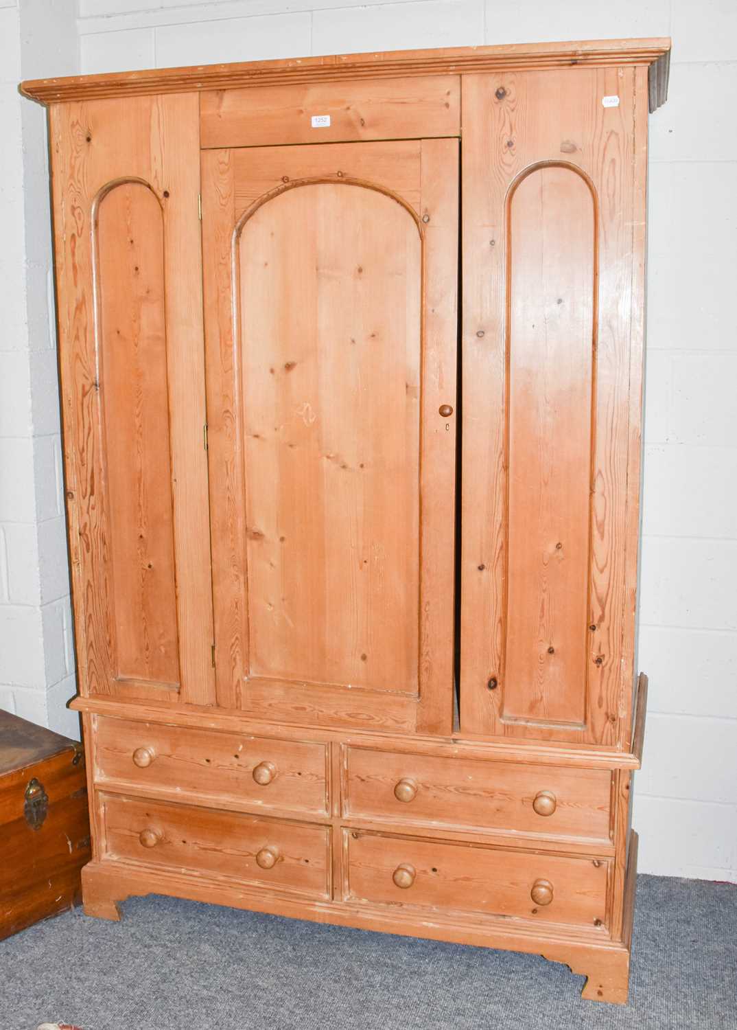 Lot 1252 - A modern pine wardrobe fitted with four base...