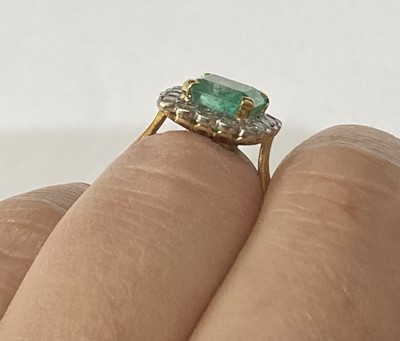 Lot 2299 - An Emerald and Diamond Cluster Ring