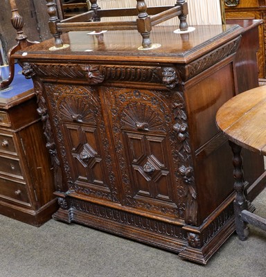 Lot 1379 - A 20th century carved oak two door cupboard...