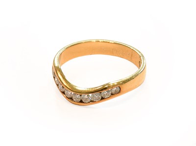 Lot 173 - A diamond half hoop ring, stamped '750',...