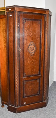 Lot 1296 - A 1920's oak standing corner cupboard the...