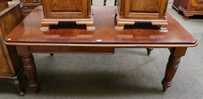 Lot 1374 - A 19th century mahogany wind out dining table...