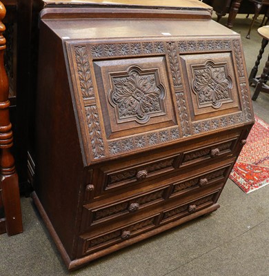 Lot 1331 - An early 20th century carved oak bureau, 92cm...