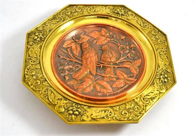 Lot 179 - Late 19th century brass and copper dish decorated with birds in foliage with a classical border
