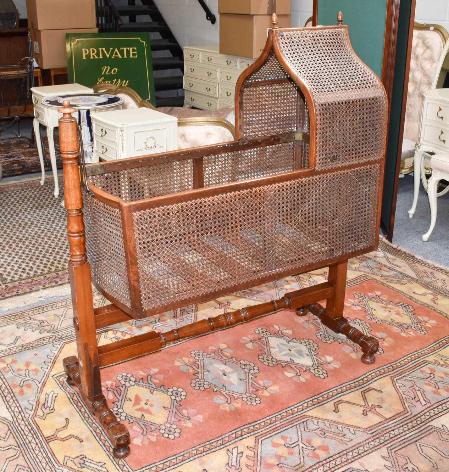 Lot 1382 - A Victorian bergere rocking cradle on mahogany...