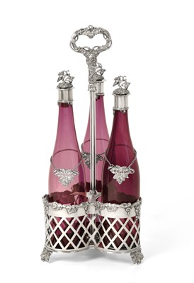 Lot 2265 - A Victorian Silver Plate Three-Bottle Decanter Stand With Three Cranberry Glass Decanters