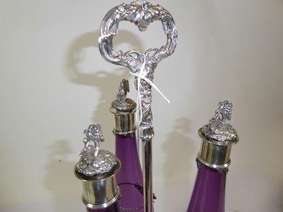 Lot 2265 - A Victorian Silver Plate Three-Bottle Decanter Stand With Three Cranberry Glass Decanters