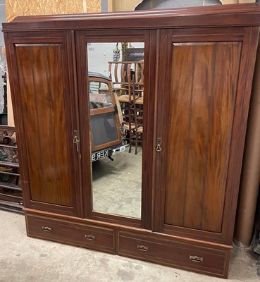 Lot 1421 - An early 20th century wardrobe with central...