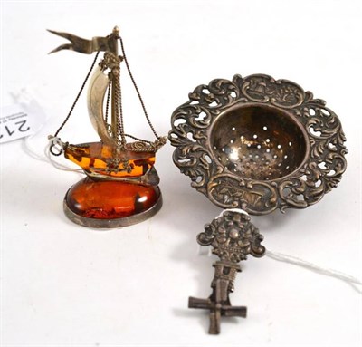 Lot 212 - Dutch silver strainer and a small silver amber mounted ship