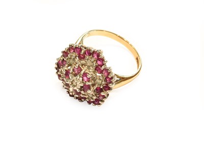 Lot 212 - A 9 carat gold ruby and diamond cluster ring,...