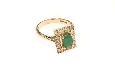 Lot 203 - An 18 carat white gold emerald and diamond...