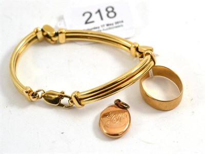 Lot 218 - A fancy link bracelet, stamped ";375";, a 9ct gold locket and a band ring (3)