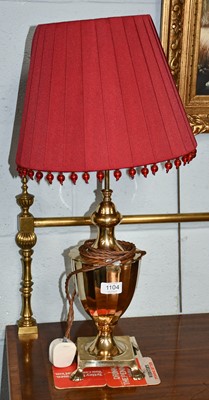 Lot 1104 - A brass table lamp with faceted urn formed...