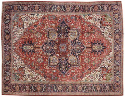 Lot 1123 - Heriz Carpet Persian Azerbaijan The salmon pink field of angular vines around a typical...