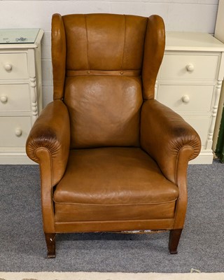 Lot 1269 - Leather wing back armchair