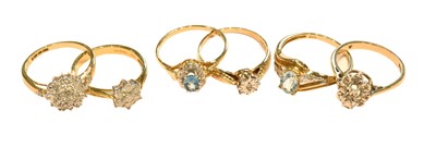 Lot 254 - An 18 carat gold diamond cluster ring, finger...