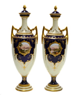 Lot 96 - A pair of Coalport twin handled pedestal vases...