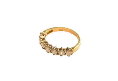 Lot 266 - An 18 carat gold diamond seven stone ring,...