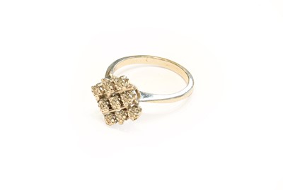 Lot 307 - A diamond cluster ring, stamped '750', finger...