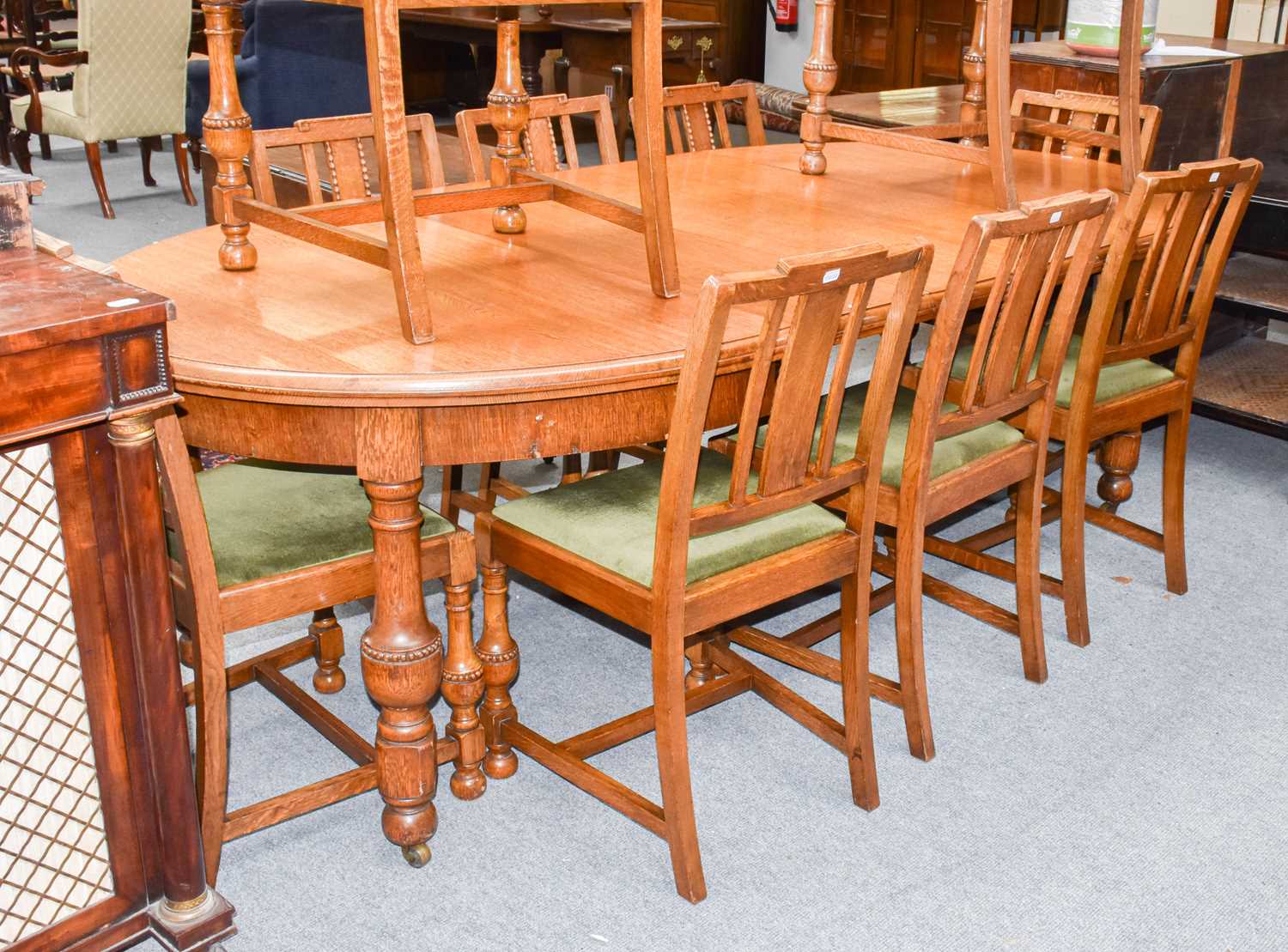 Lot 1238 - A 20th century oak wind out dining table with...