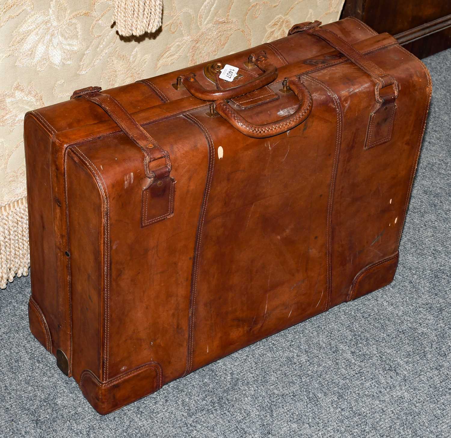 Lot 1407 - A 20th century leather suitcase