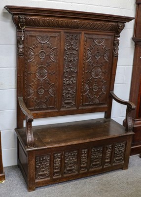 Lot 1280 - A 20th century carved oak box settle, the high...