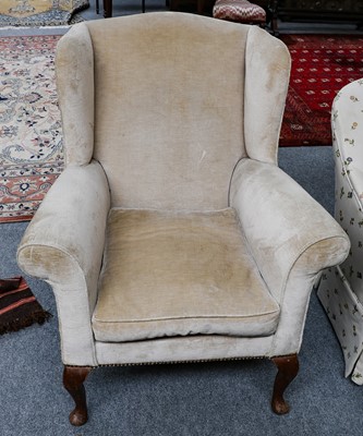 Lot 1266 - A wing chair with cream upholstery