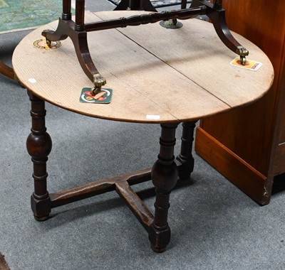 Lot 1230 - An oak corner table, with circular drop leaf...