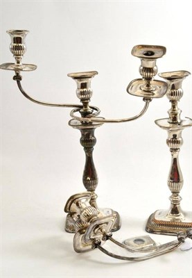 Lot 291 - A pair of Old Sheffield Plate candelabra, each with rectangular bases with reeded decoration...