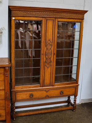 Lot 1104 - A 1920's oak bookcase with leaded glazed doors,...