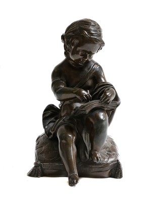 Lot 326 - A 19th century bronze of a putto seated on a...