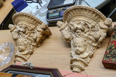 Lot 313 - A pair of plaster wall brackets decorated with...