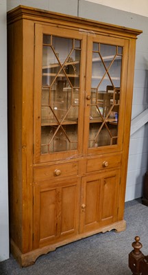 Lot 1210 - A large 20th century pine part glazed bookcase,...
