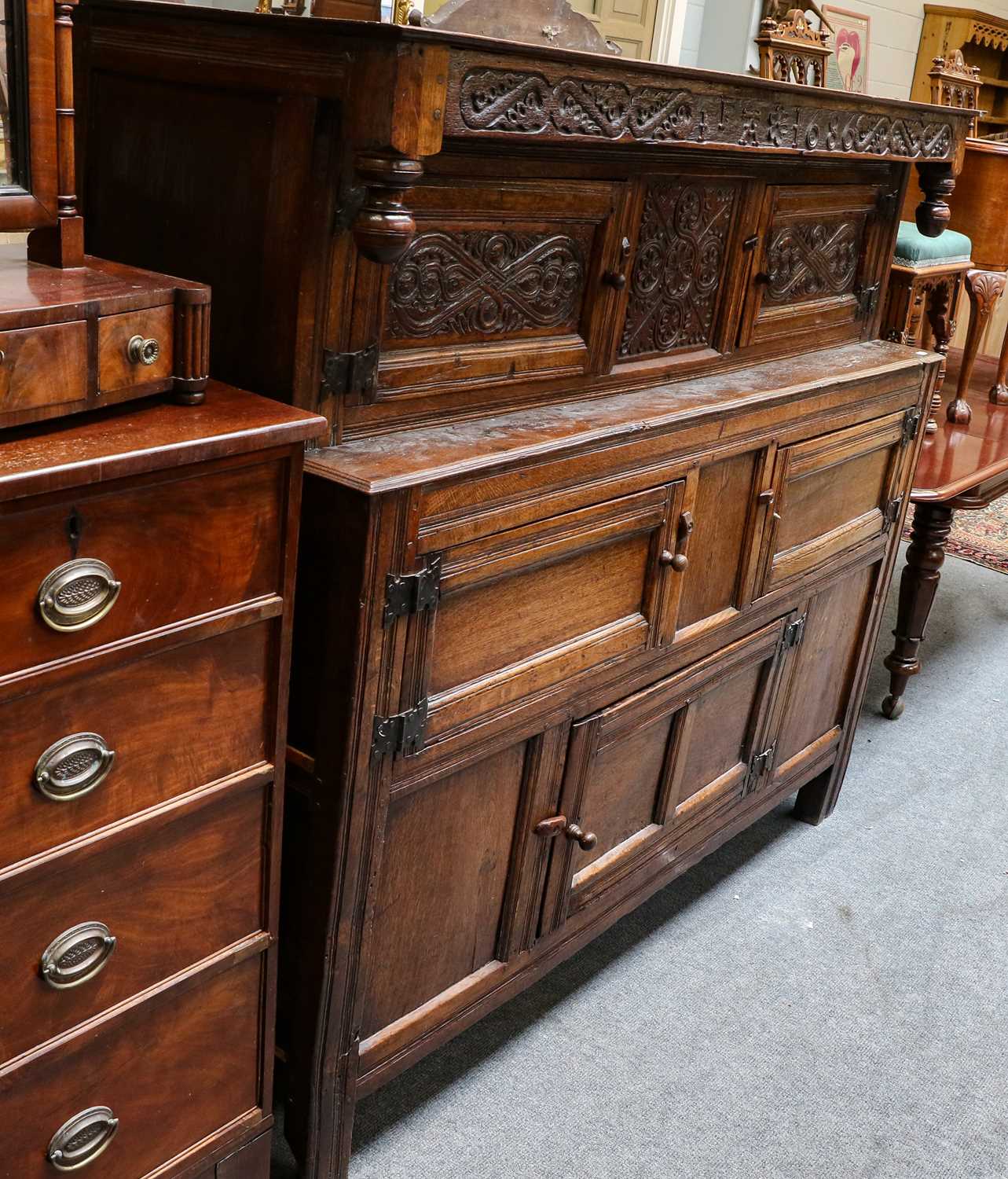 Lot 1222 - A 17th century carved oak court cupboard,...