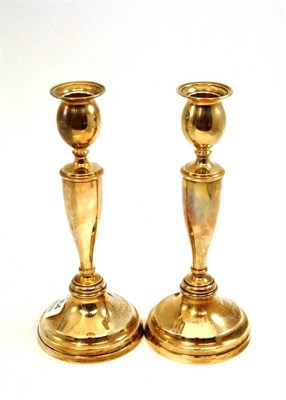 Lot 304 - Pair of loaded silver table candlesticks