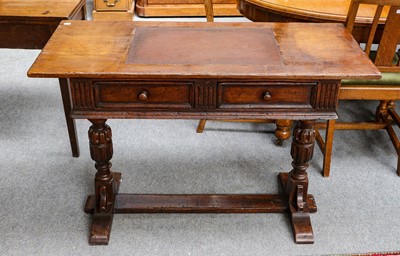 Lot 1393 - A 20th century oak writing table, 115cm by...