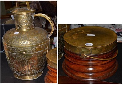 Lot 316 - A brass mounted mahogany foot warmer and a large lidded jug embossed with lions and flowers and...