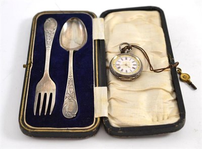 Lot 325 - A silver cased lady's watch and a silver cased fork and spoon