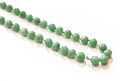 Lot 370 - A graduated jade bead necklace, knotted to a...