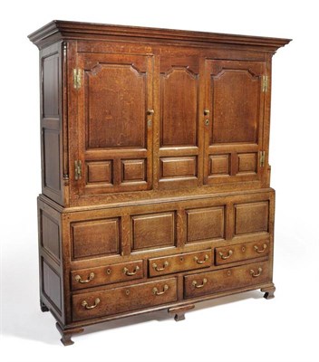 Lot 1131 - An 18th Century Joined Oak Clothes Press, Northern Region, the bold cornice above two fielded panel